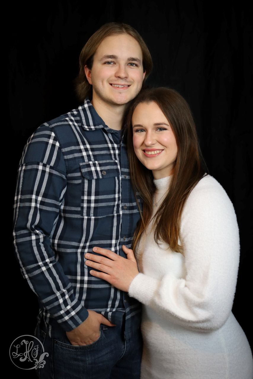 3/4 Couple Portrait on black backdrop