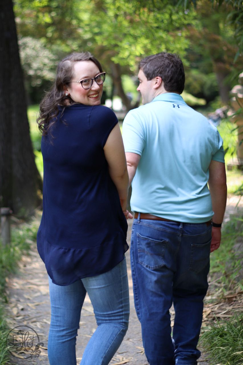 Couple walking away, woman looking back