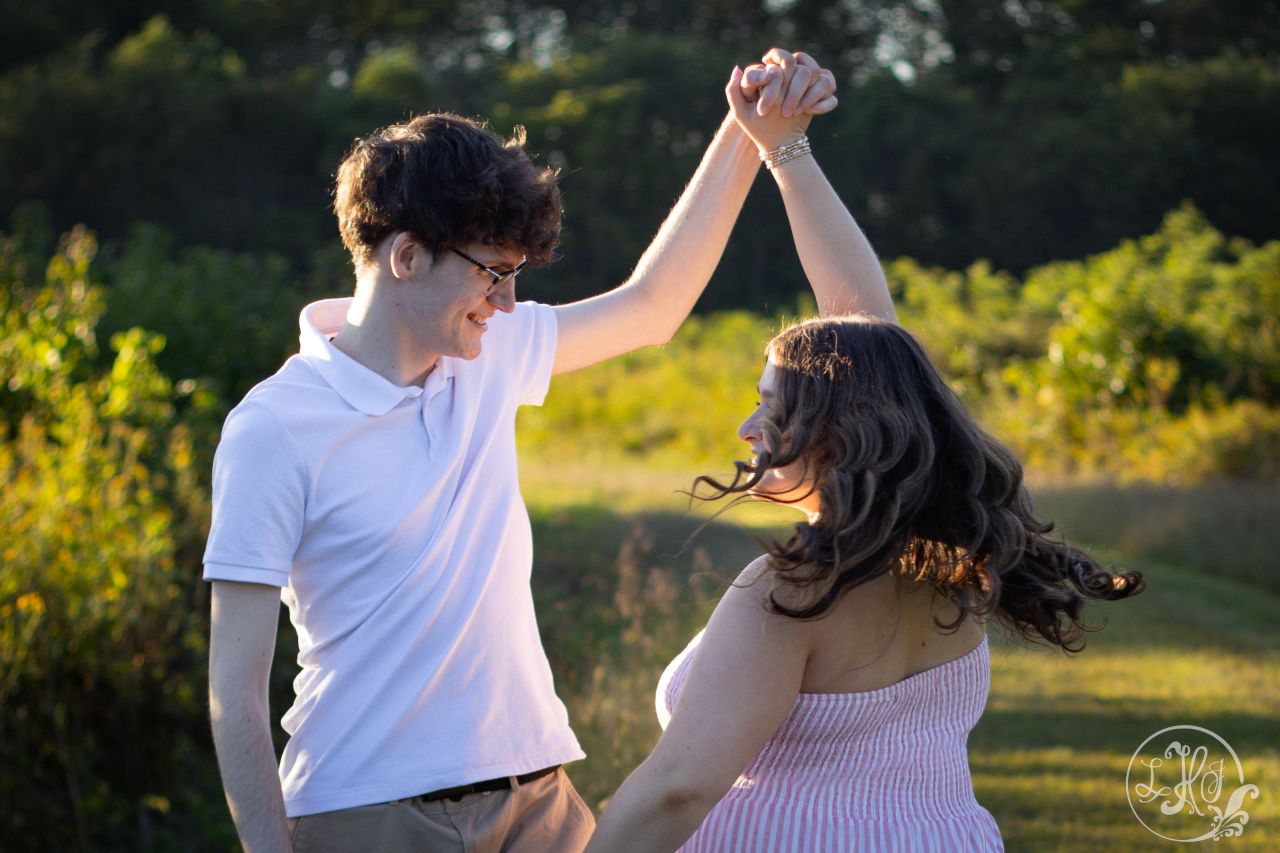Photo of couple twirling in golden light