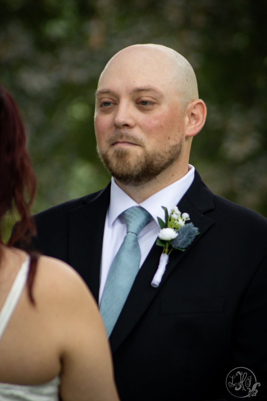 3/4 photo of groom during wedding ceremony