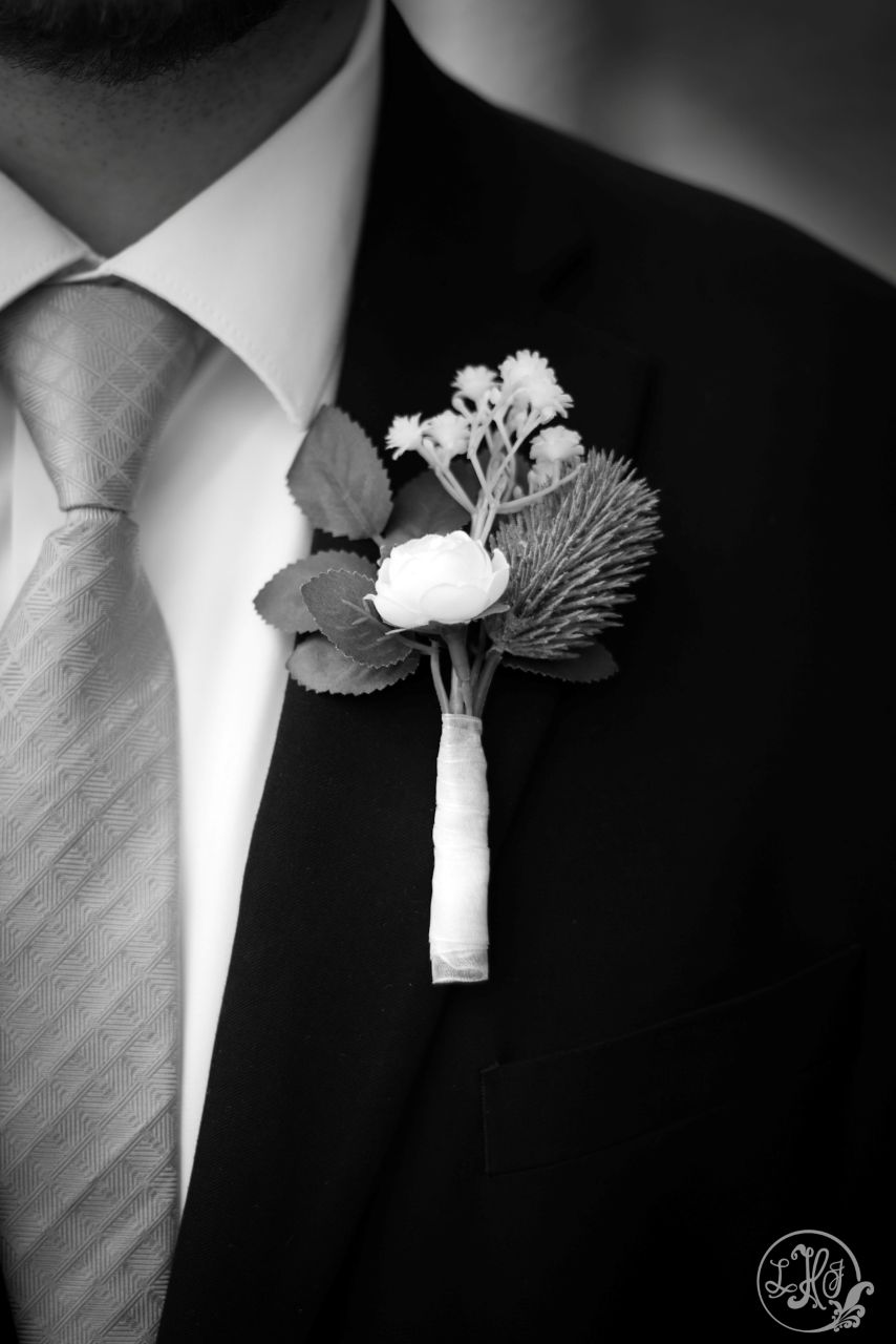 Black and white close up of groom's boutonniere