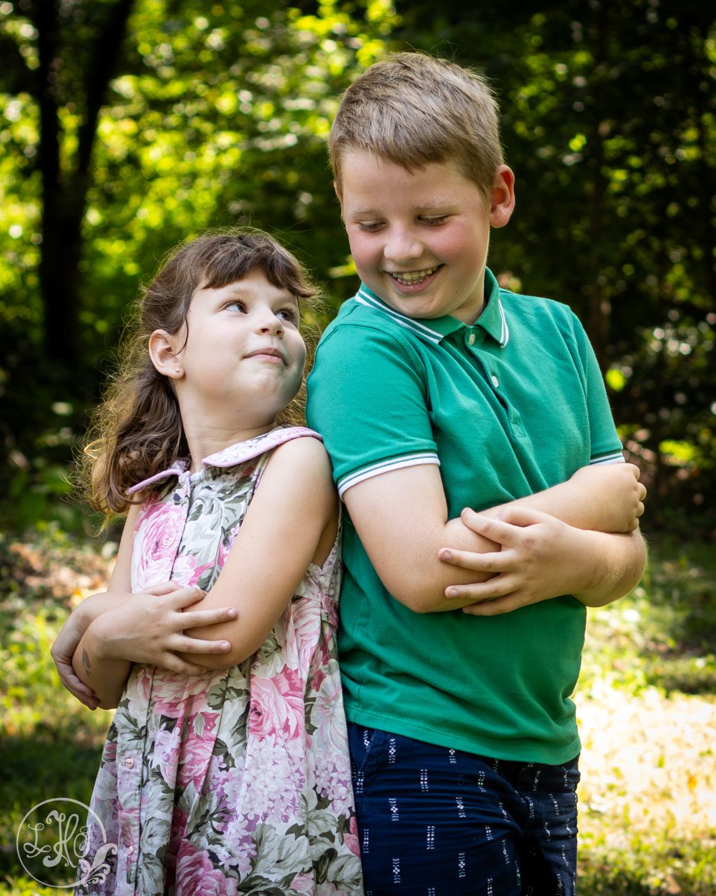 Photo of brother and sister standing back to back