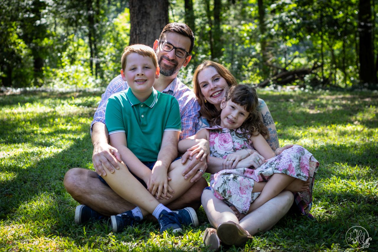 Family photo of kids in parents' lap