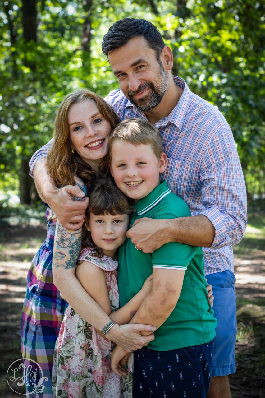Photo of family of 4 group hug