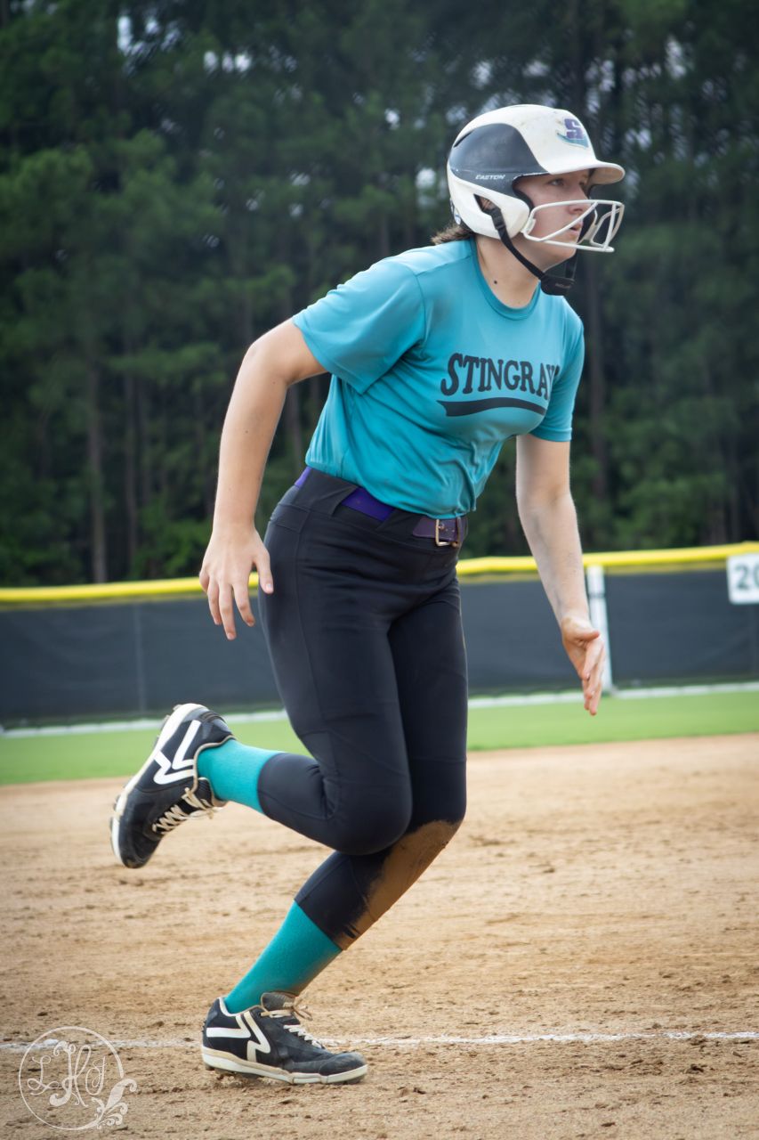 Photo of Softball player running to home base