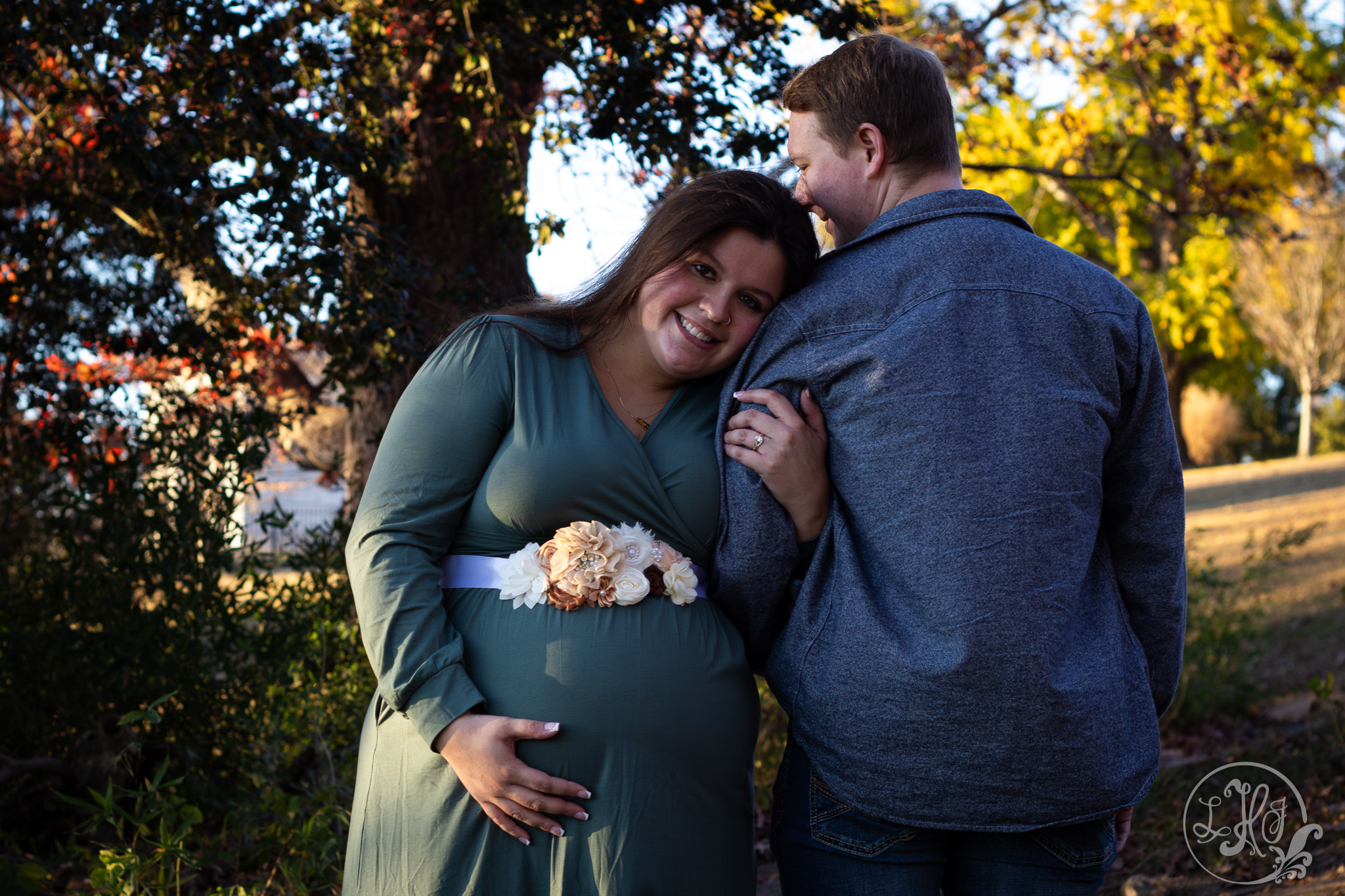 Expecting mother holding father-to-be's arm