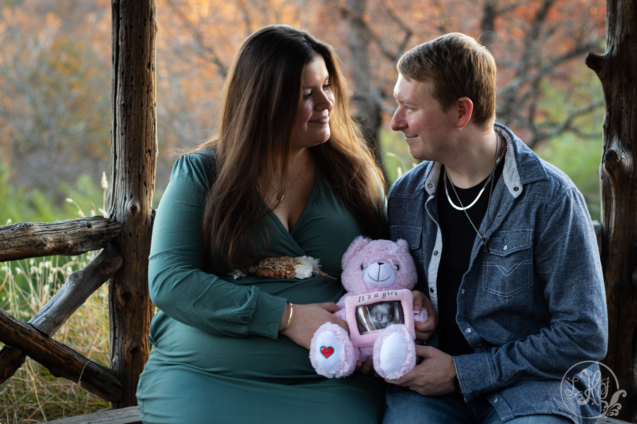 Maternity photo of expecting parents holding bear with ultrasound photo