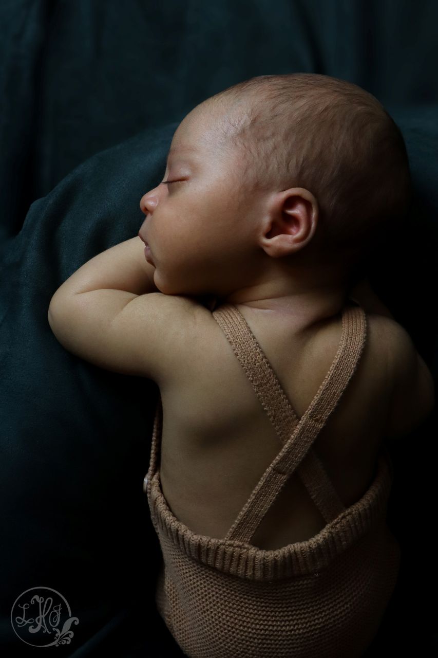 Vertical Newborn Portrait from Above-Baby in knitted overalls